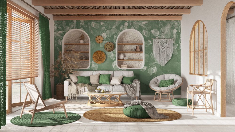 Una sala de estar con un sofá, sillas, una mesa y una pared verde.