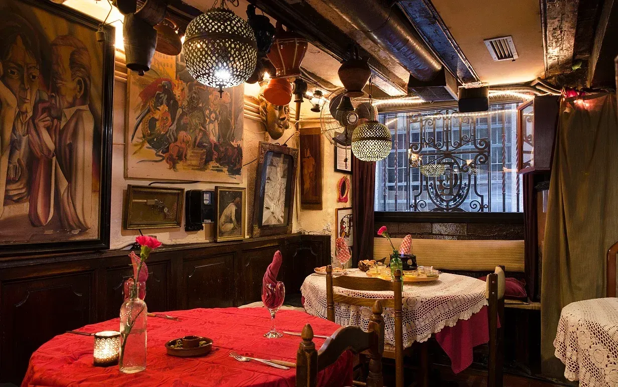 Un comedor con una mesa y sillas y un cuadro en la pared.