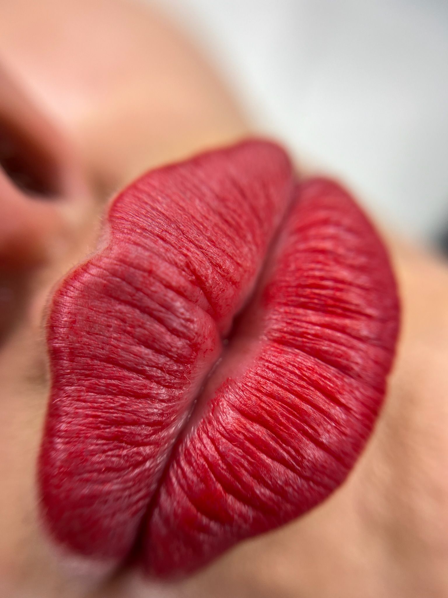 Primer plano de unos labios rojos y carnosos, ligeramente separados.