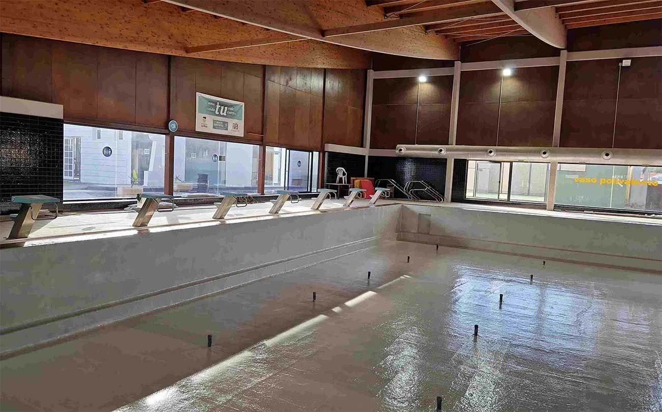 Hay una gran piscina en el medio de un edificio.
