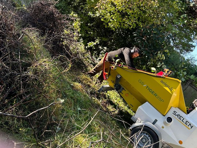 L'artisan utilise un broyeur de branches