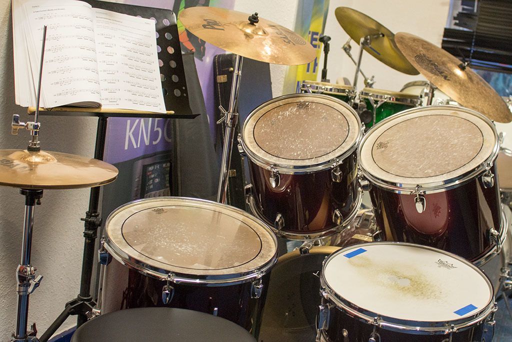 Ein Schlagzeug steht vor einem Schild mit der Aufschrift knsc