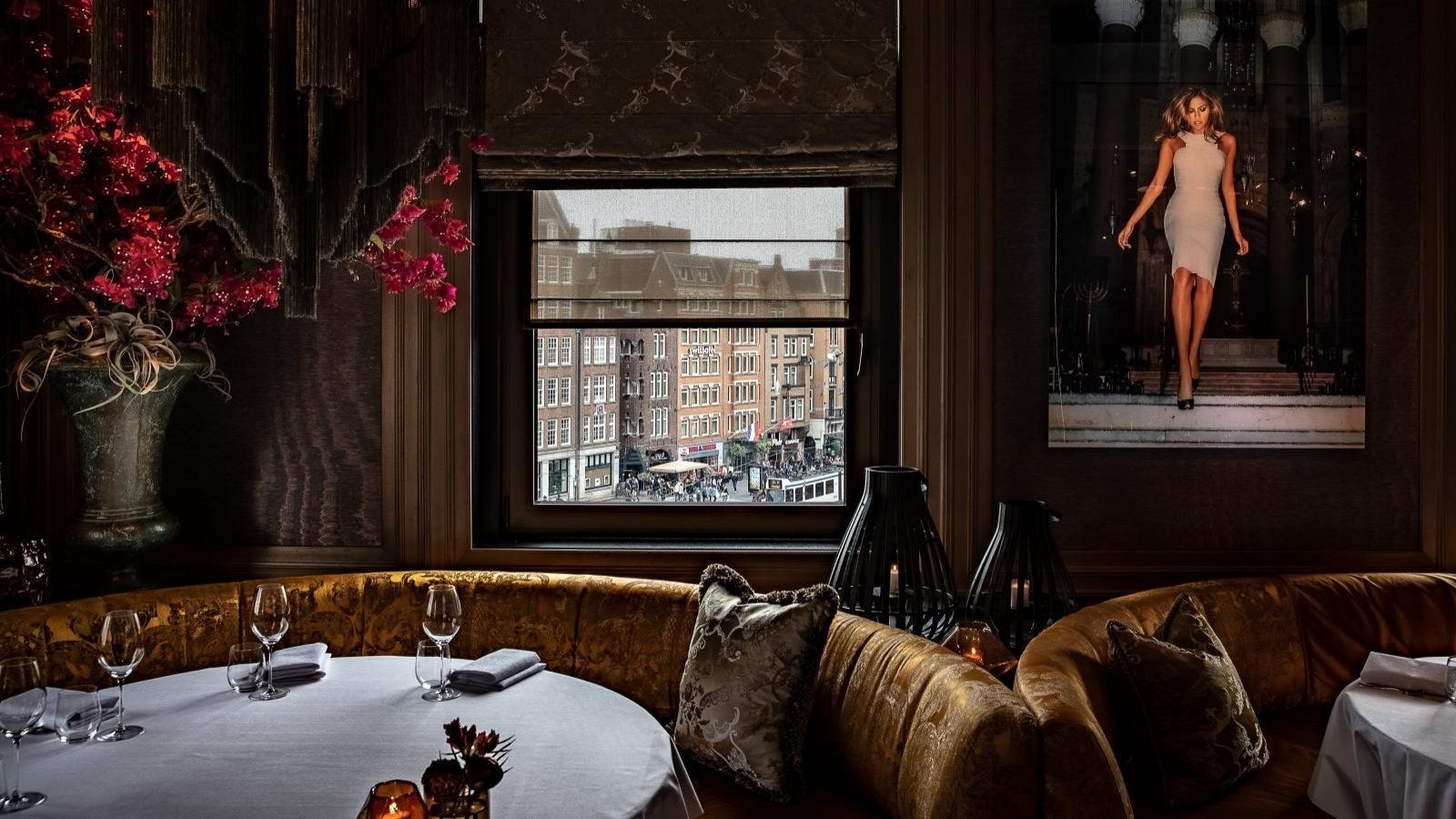 Hand arranging plated gourmet appetizers on a long rectangular dish