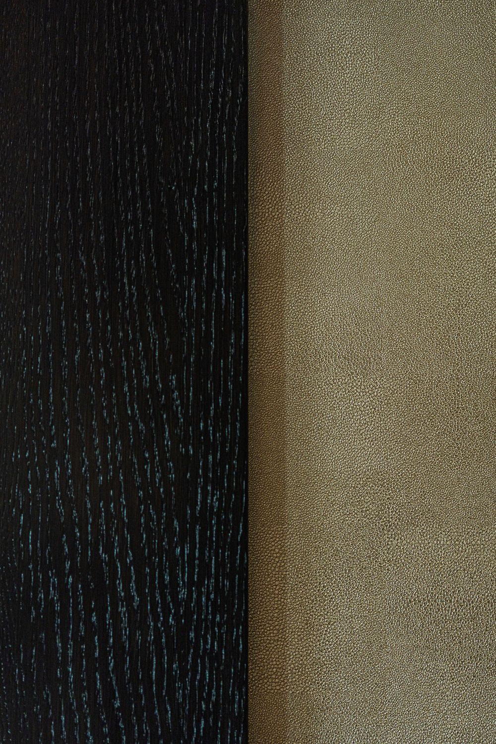 Close-up of two textured vertical panels, one black and one gold.