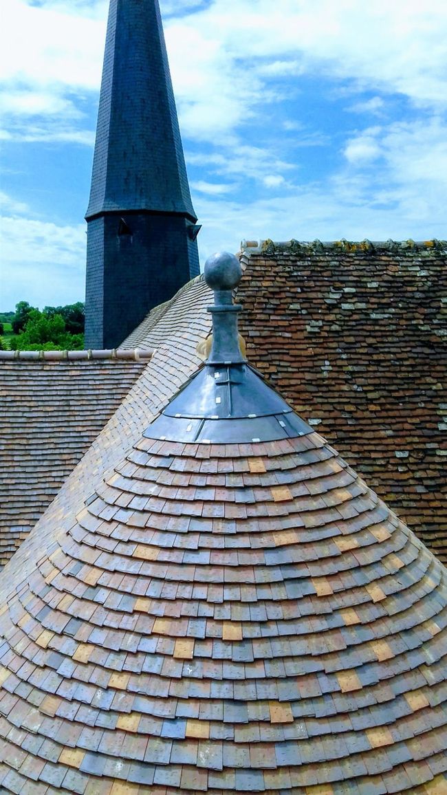 Travaux de zinguerie avec mise en place d'une pointe sur le sommet d'une toiture en tuiles plates