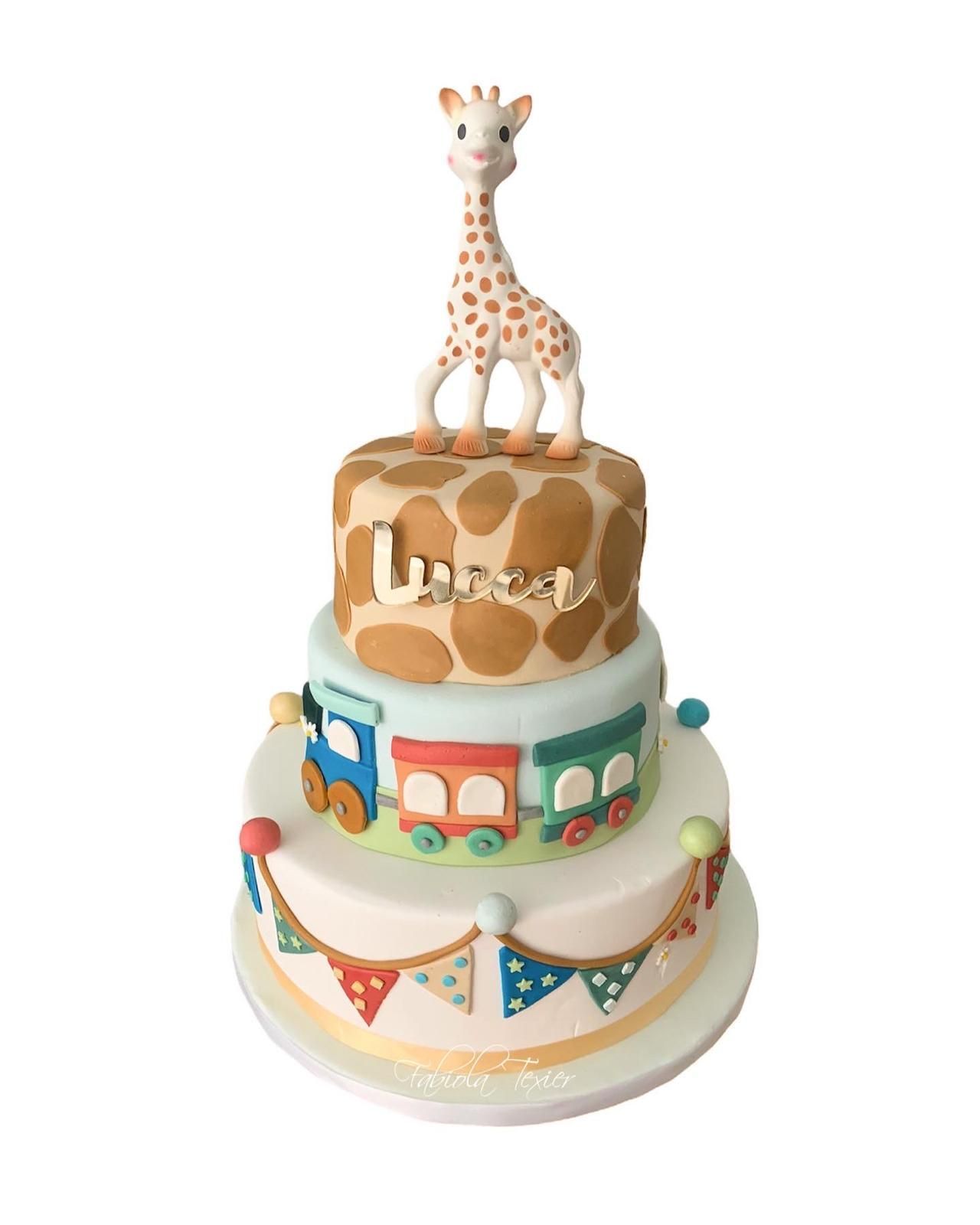 Un pastel con una jirafa encima.