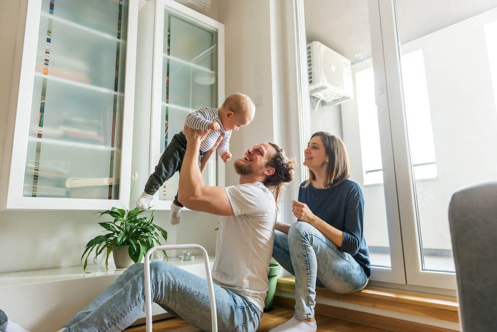 A man and woman are sitting on a couch with two children.