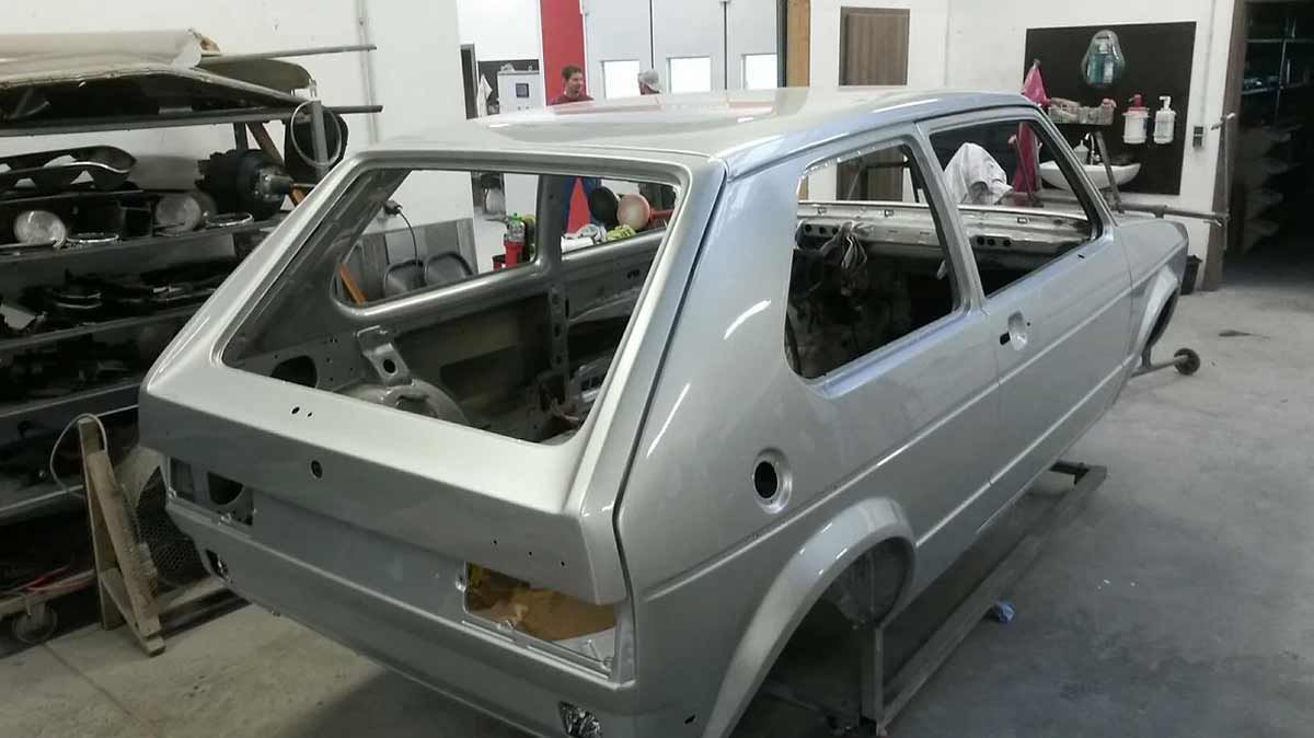 In einer Garage wird ein silbernes Auto gebaut