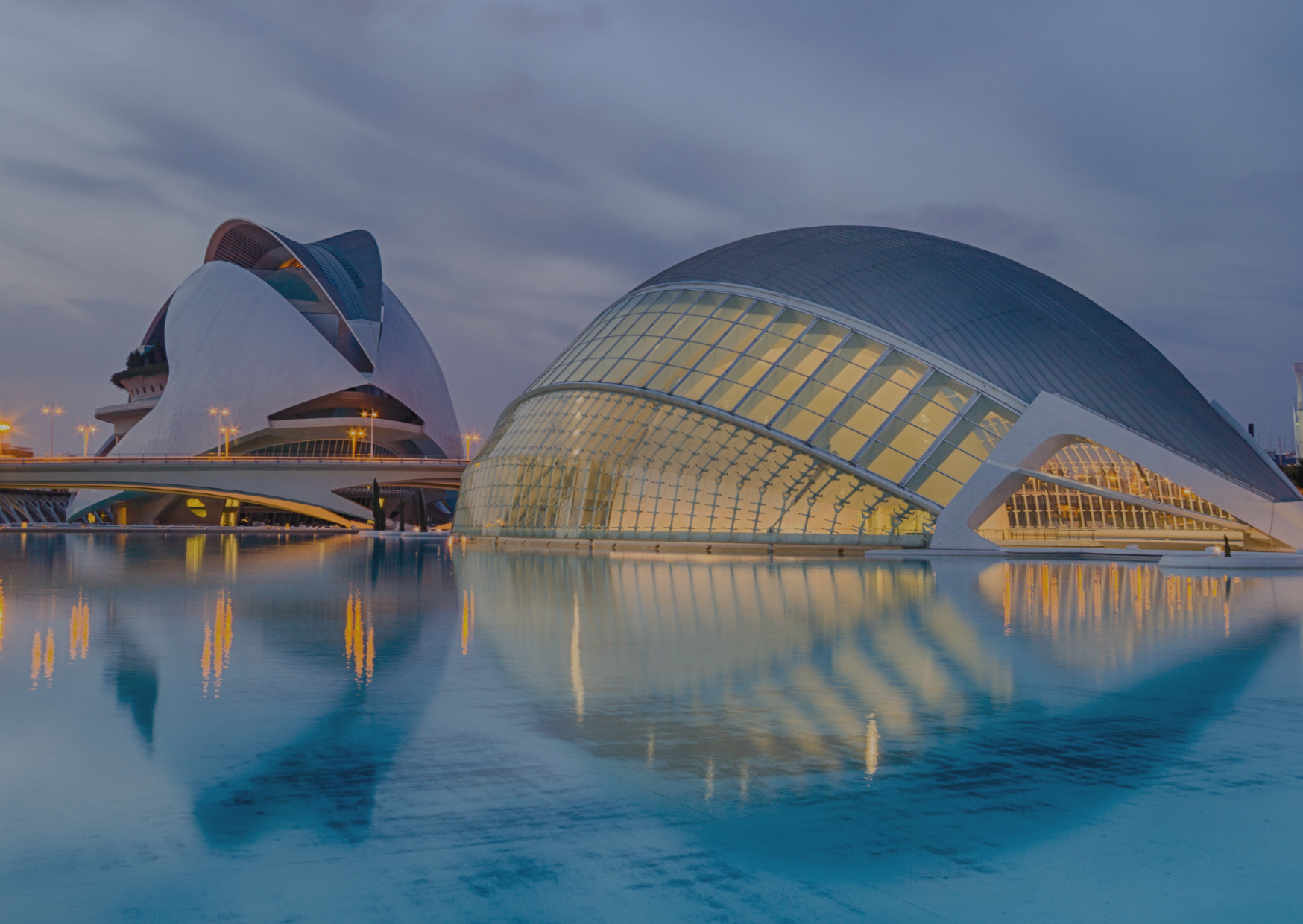 A large building is reflected in a body of water.