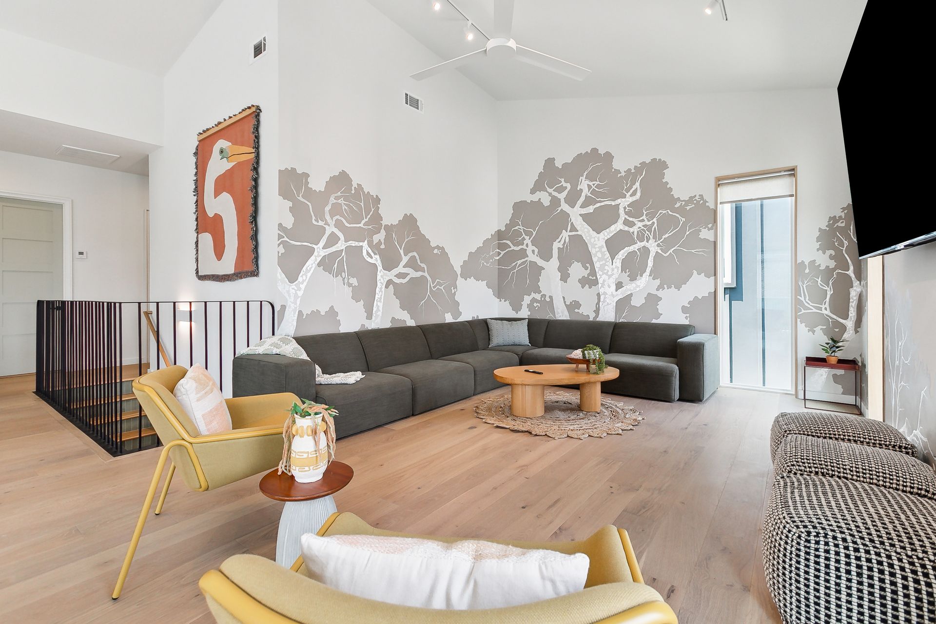 A living room with a couch , chairs and a table