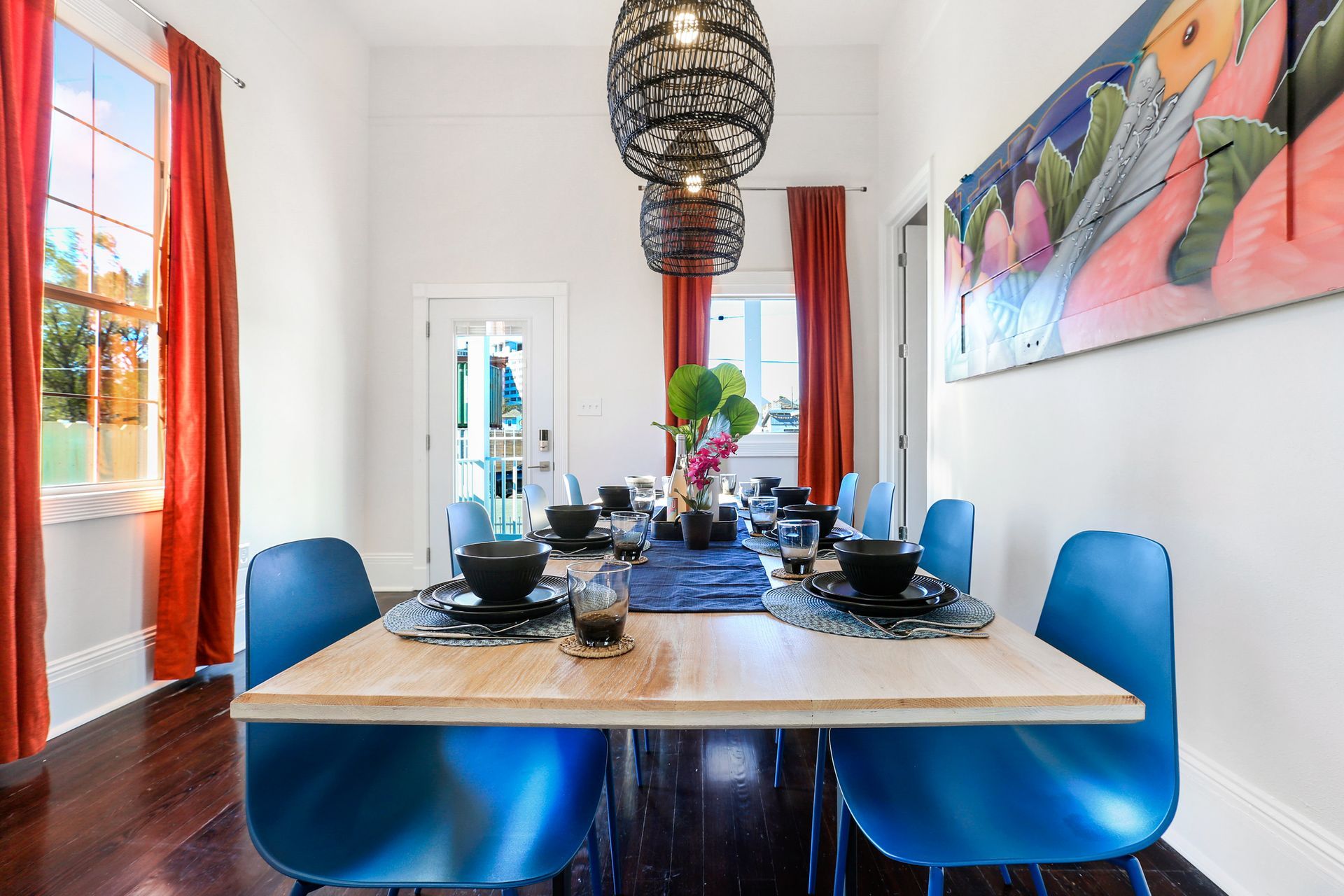 A dining room with a long table and blue chairs