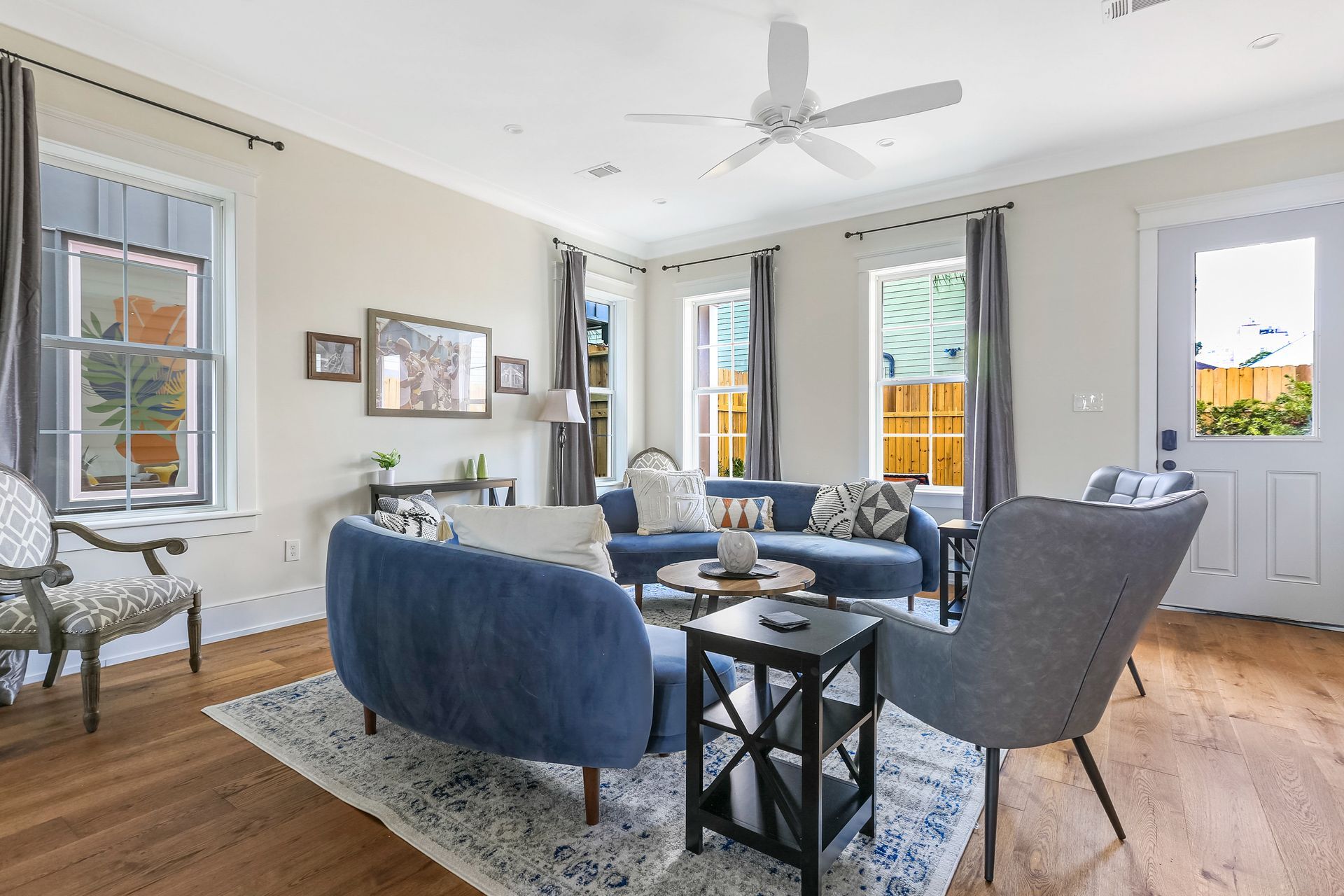 A living room filled with furniture and a ceiling fan.