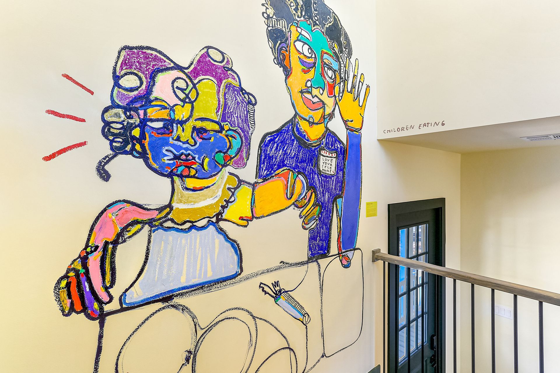 A staircase with a painting of a man and woman on the wall.