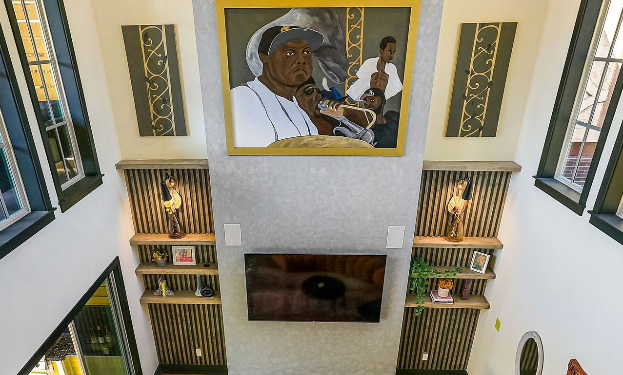 An aerial view of a living room with a picture of a man on the ceiling