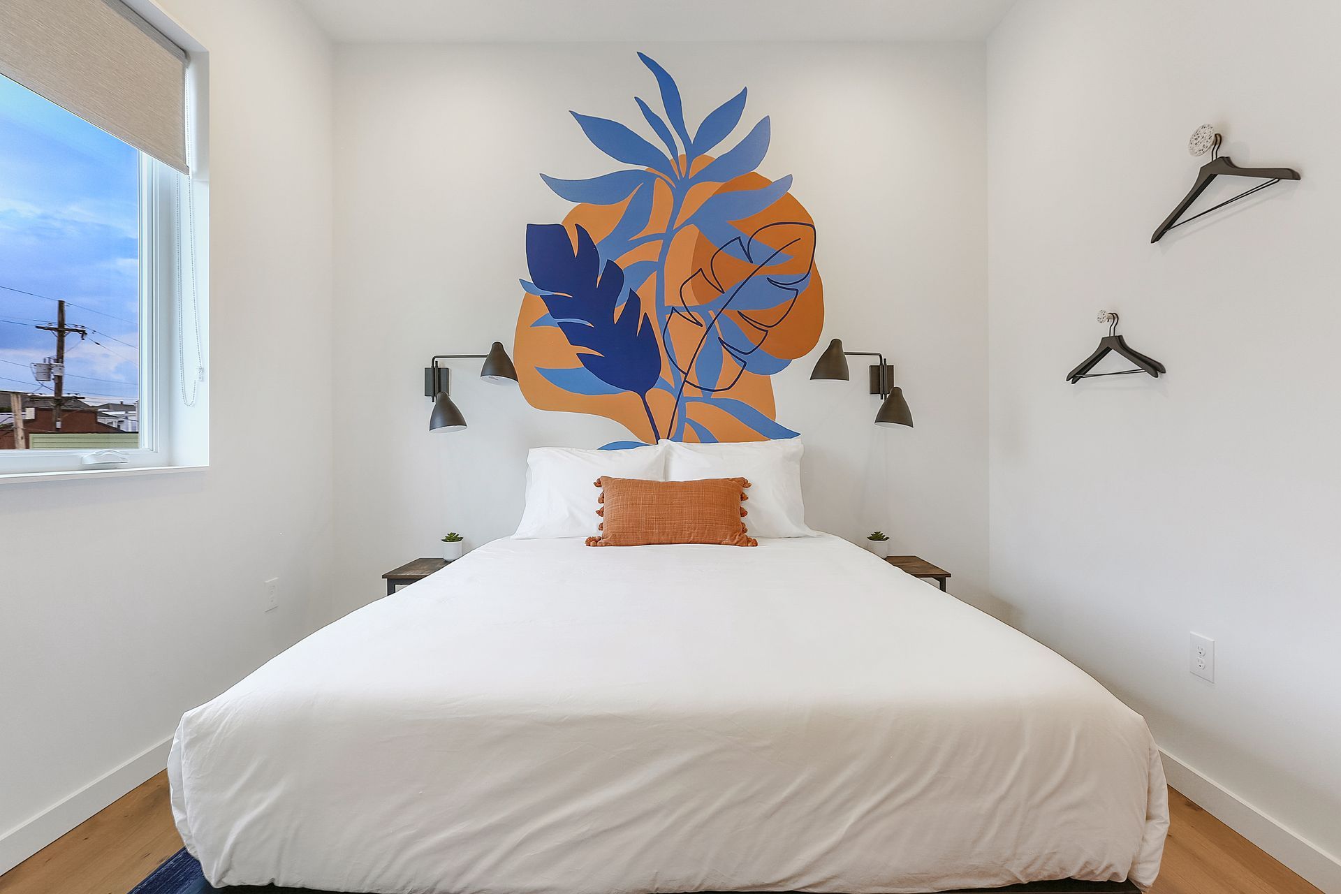 A bedroom with a bed and a painting on the wall