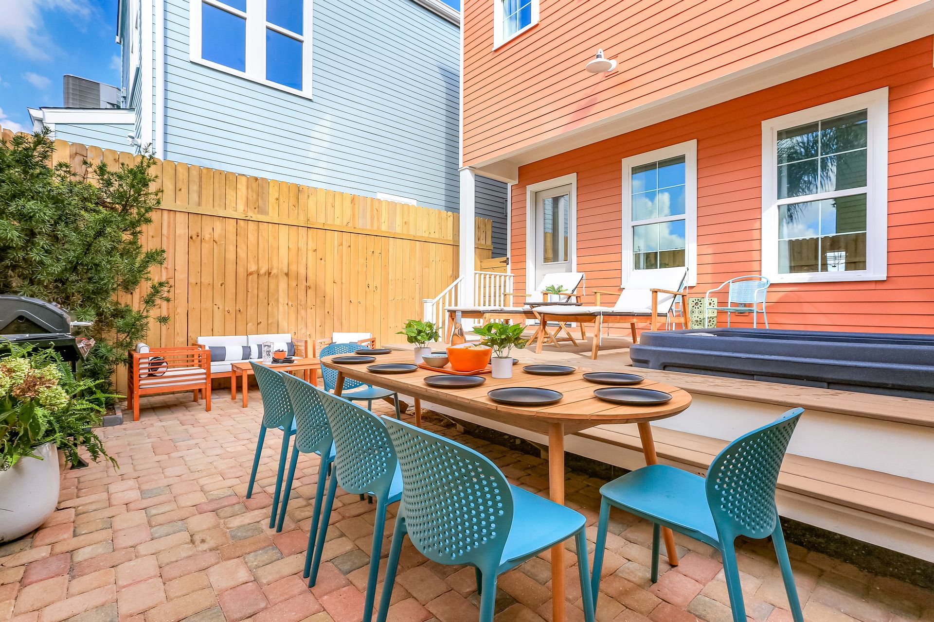 A patio with a table and chairs in front of a house.