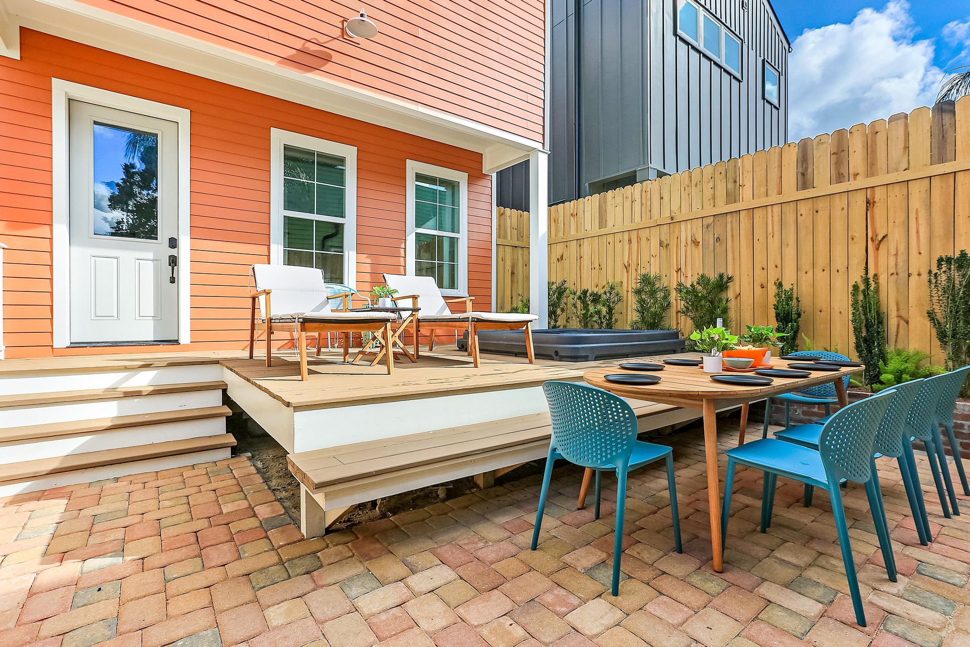 A patio with a table and chairs in front of a house.