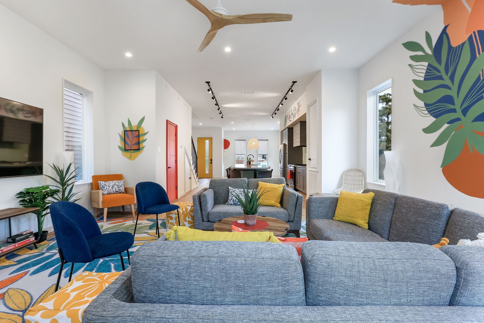 A living room filled with furniture and a ceiling fan.