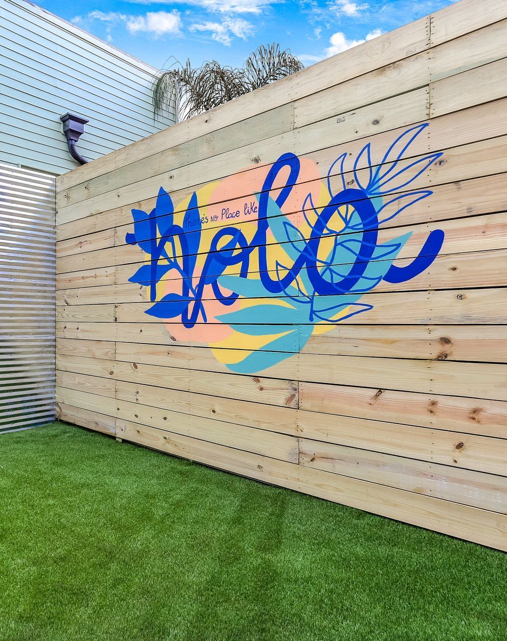 A wooden fence with the word hello painted on it