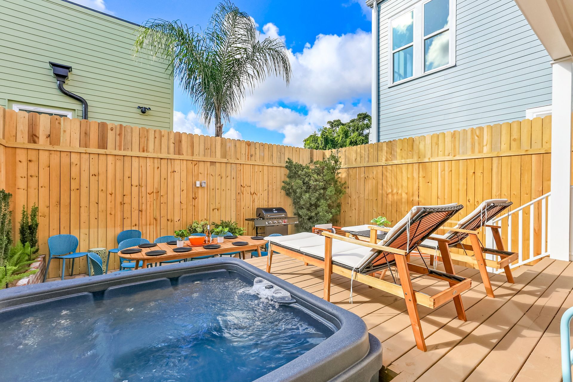 There is a hot tub on the deck of a house.