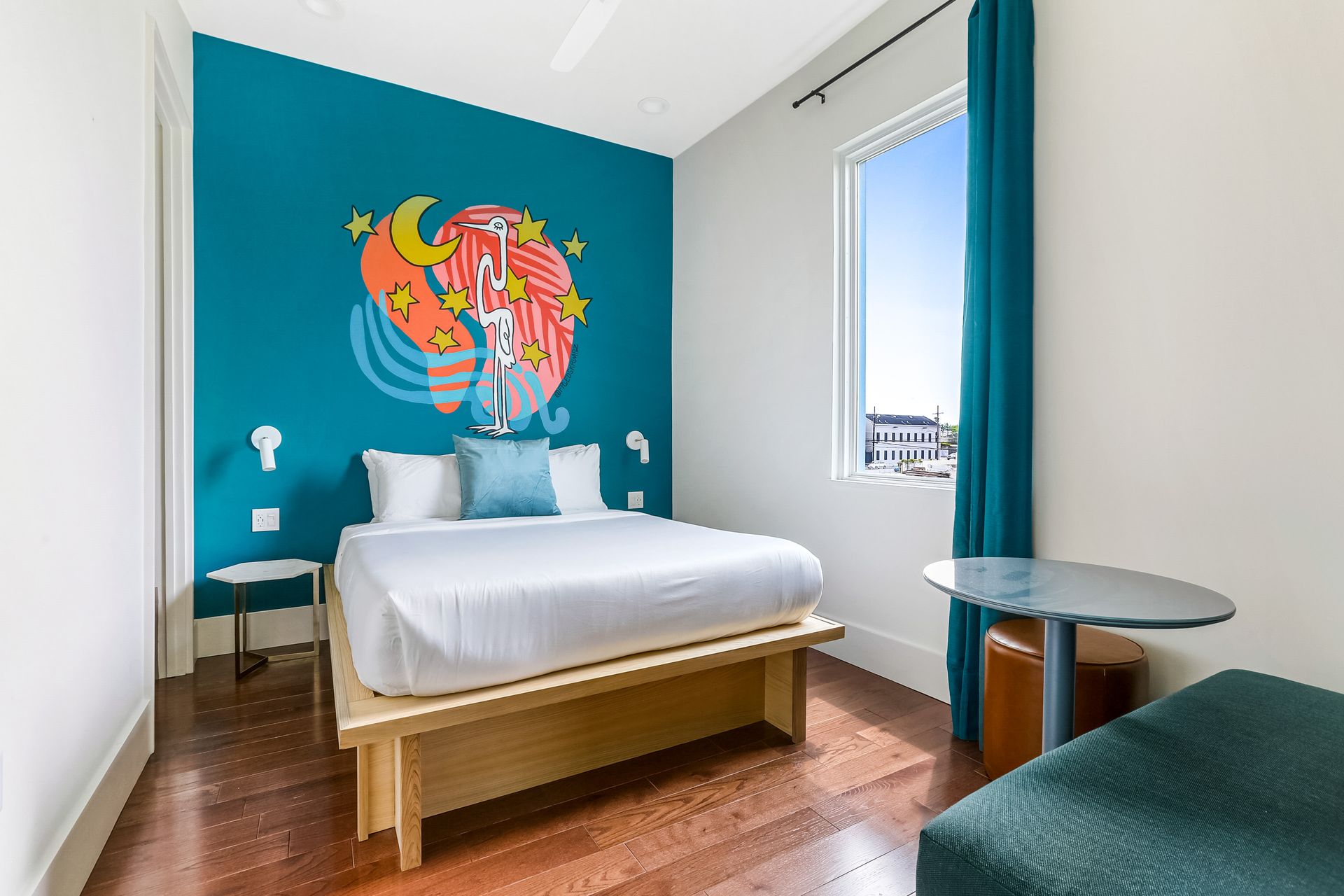 A hotel room with a bed and a table