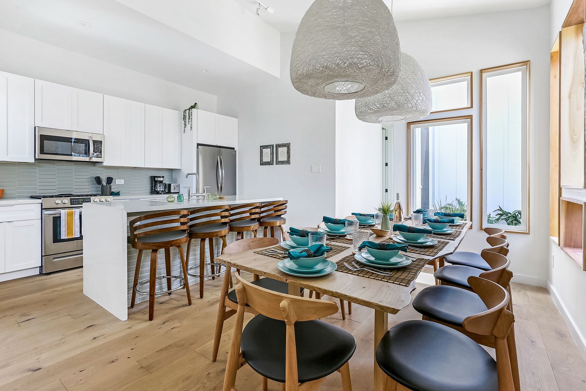 A kitchen with a dining table and chairs in it