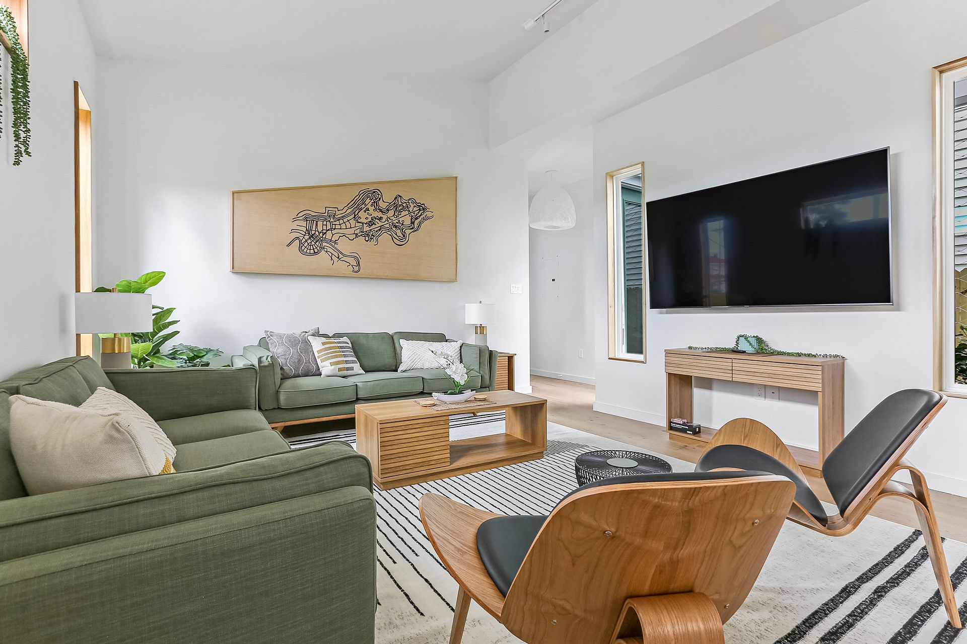 A living room filled with furniture and a flat screen tv.