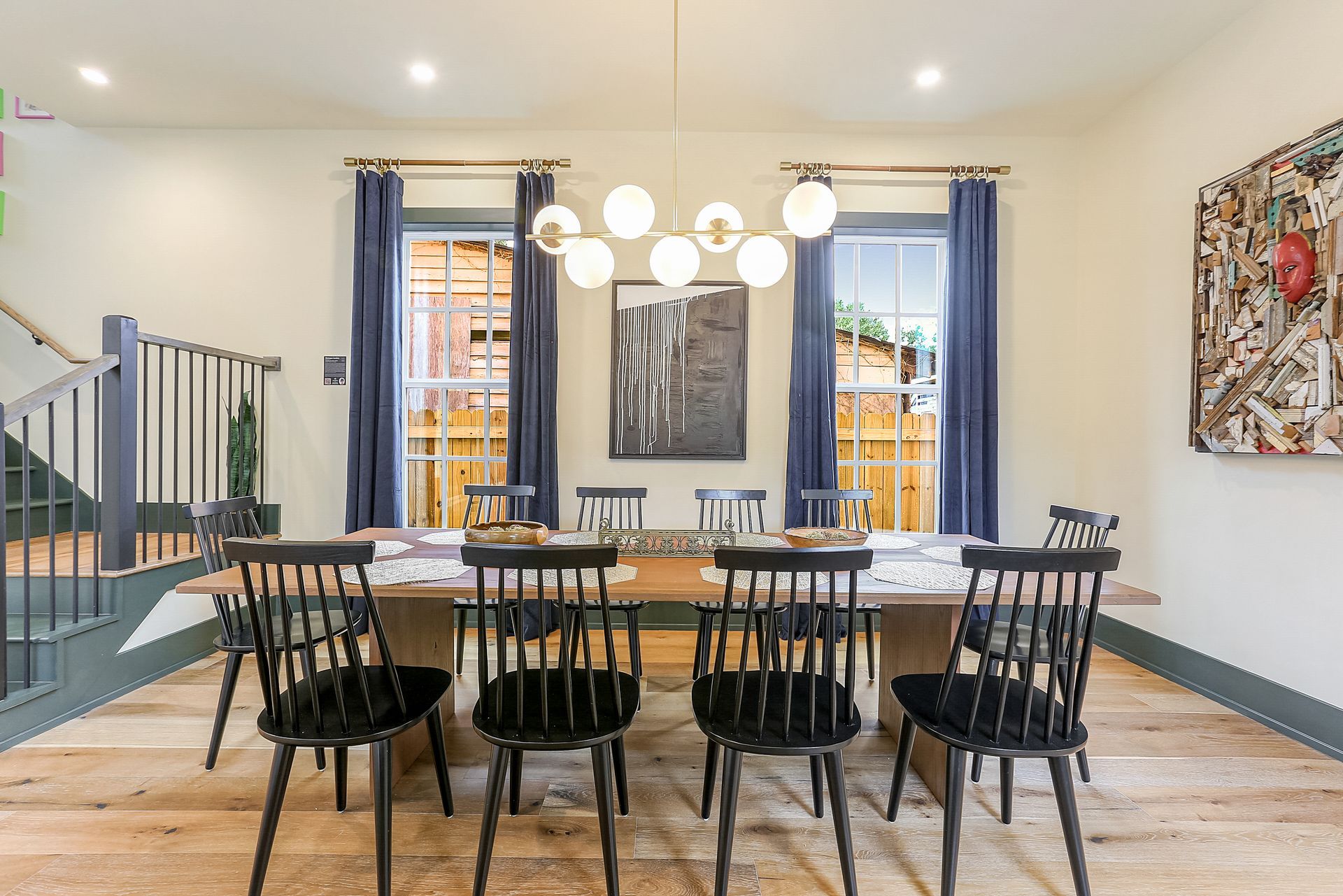 A dining room with a table and chairs and a chandelier.