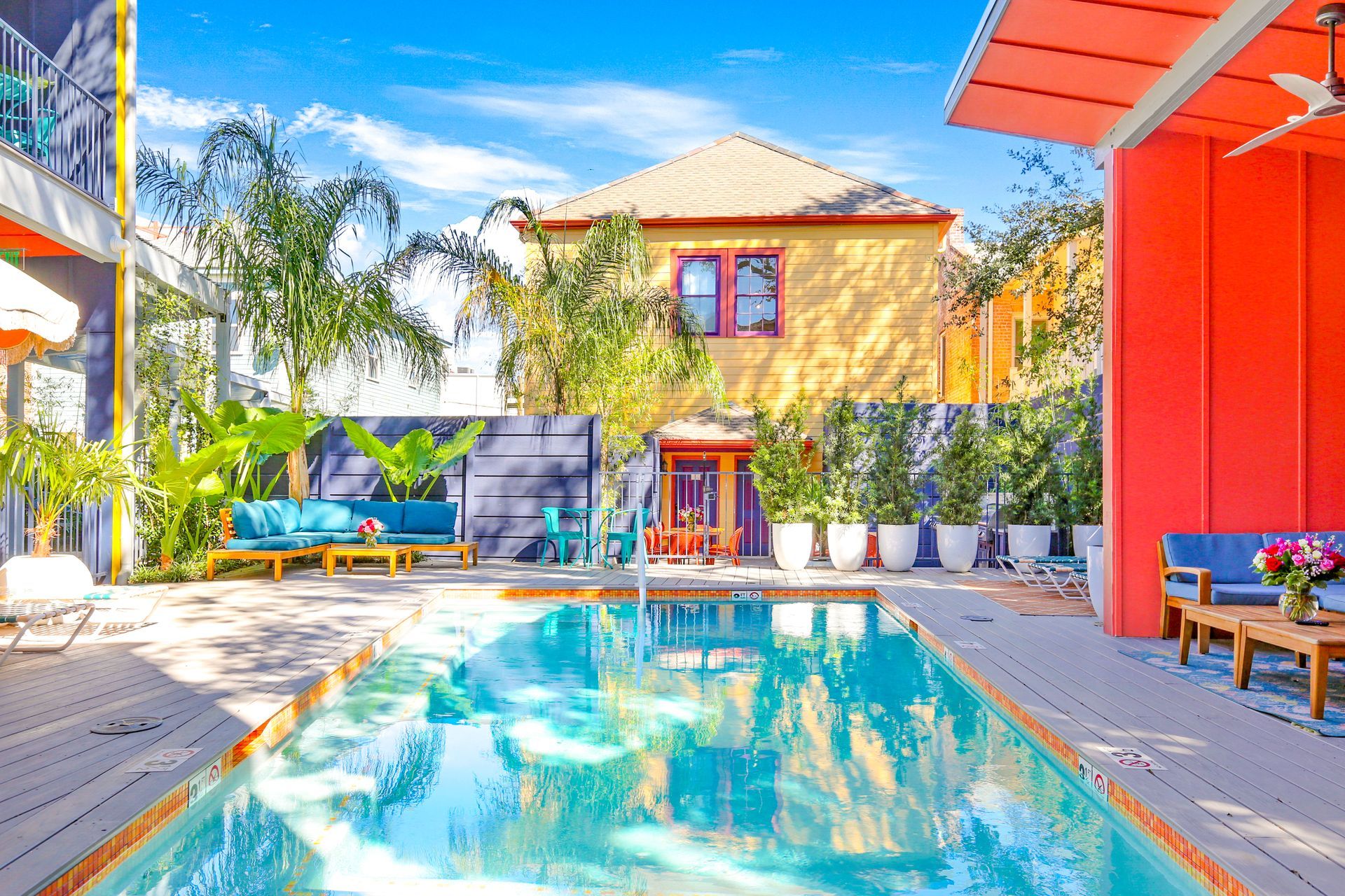 A large swimming pool in front of a colorful house