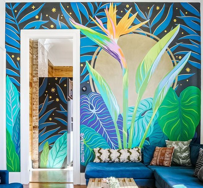 A living room with a painting of a bird of paradise on the wall
