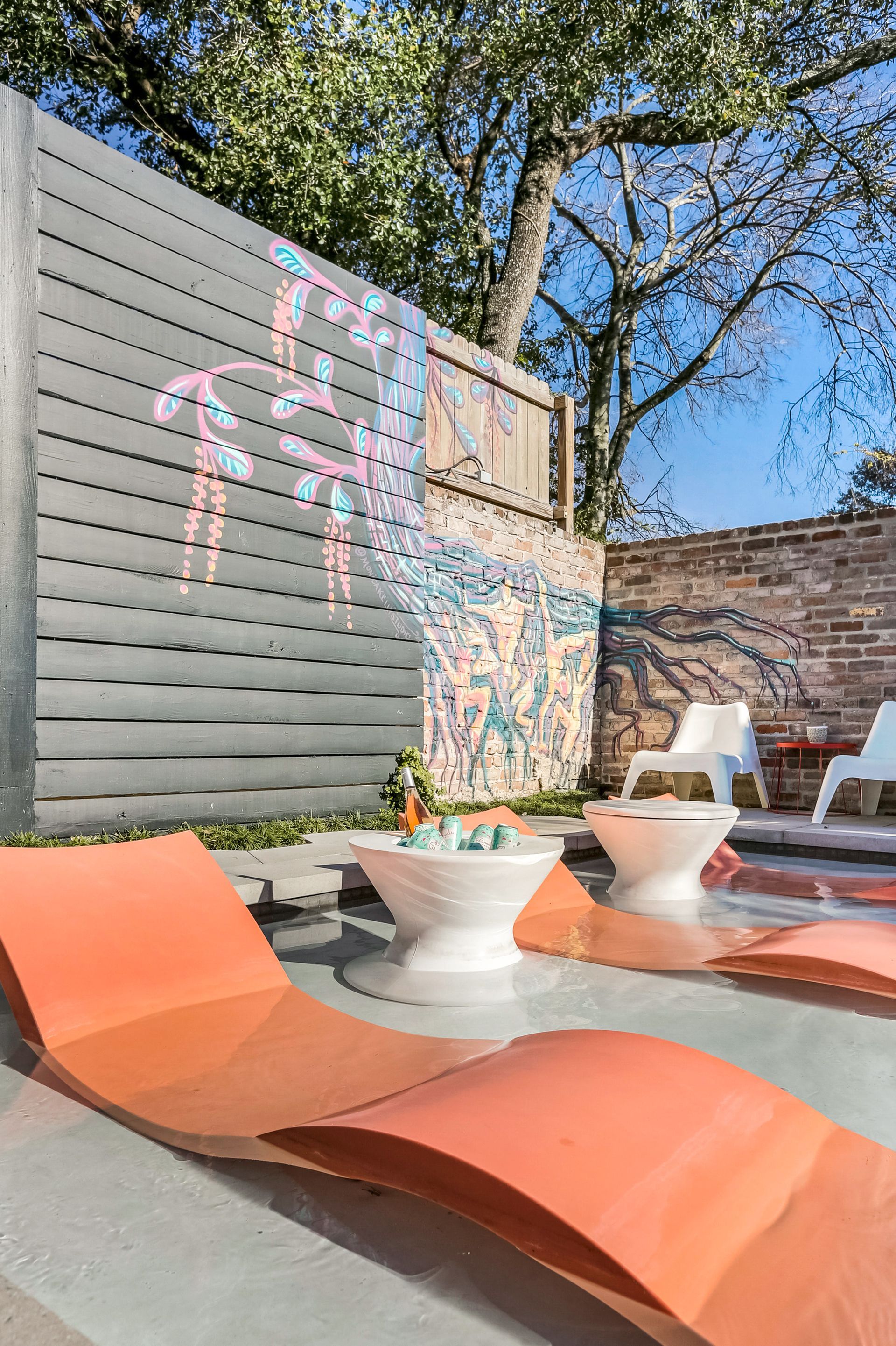 There are a lot of chairs and tables in the backyard.