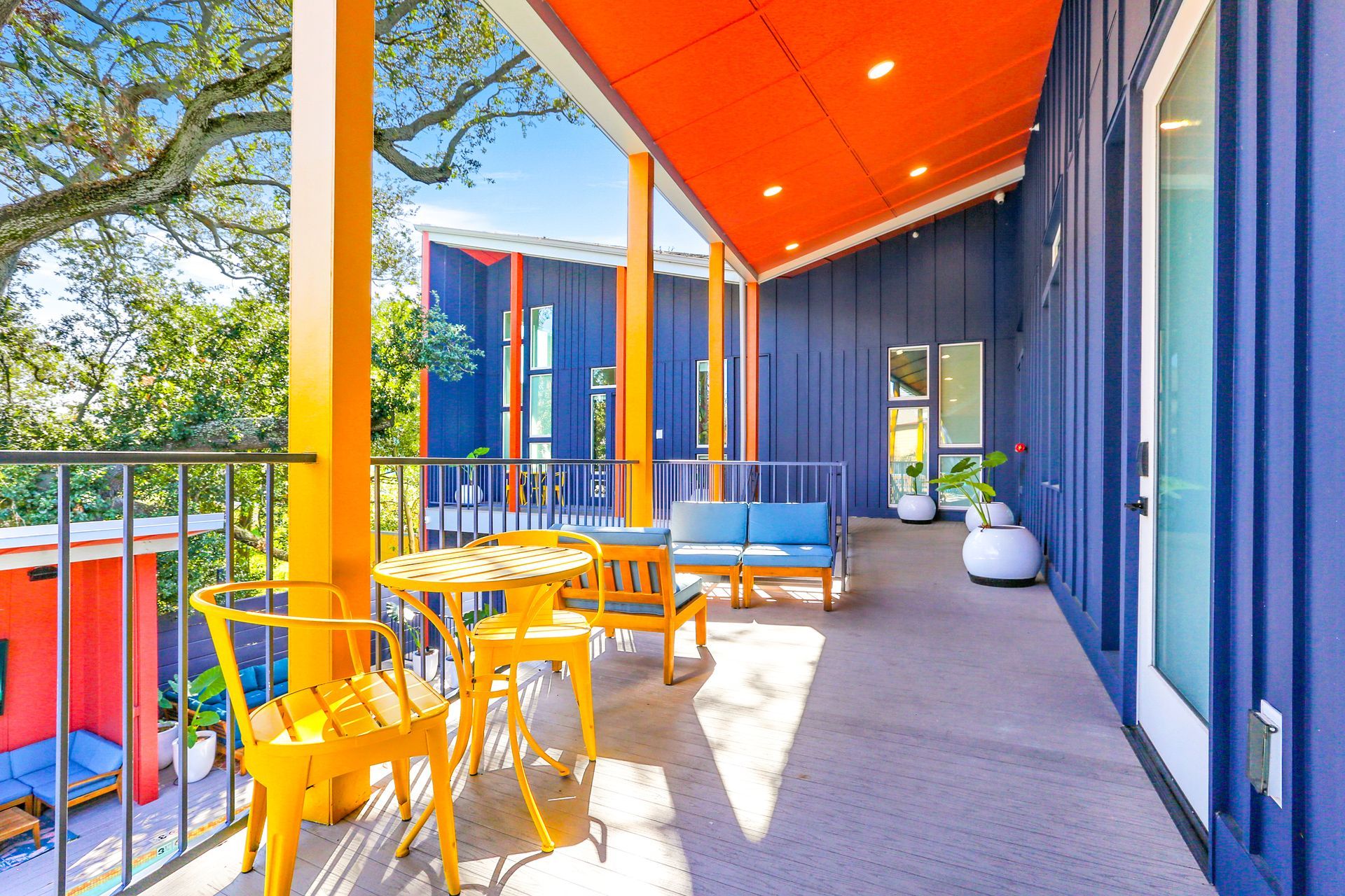 There is a balcony with a table and chairs on it.