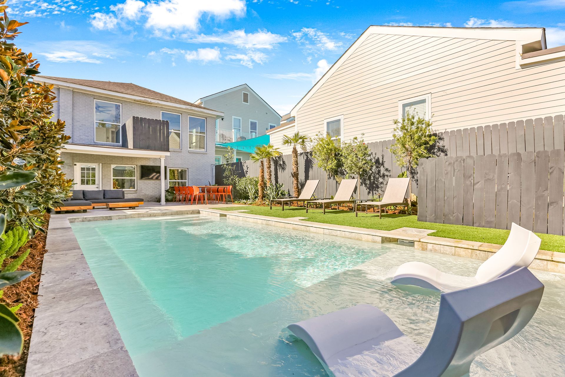 A large swimming pool in the backyard of a house