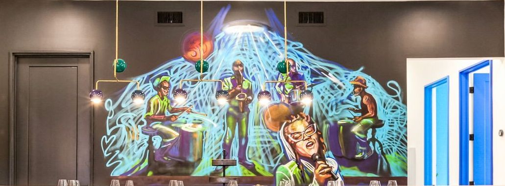 There is a painting of scooby doo on the wall.