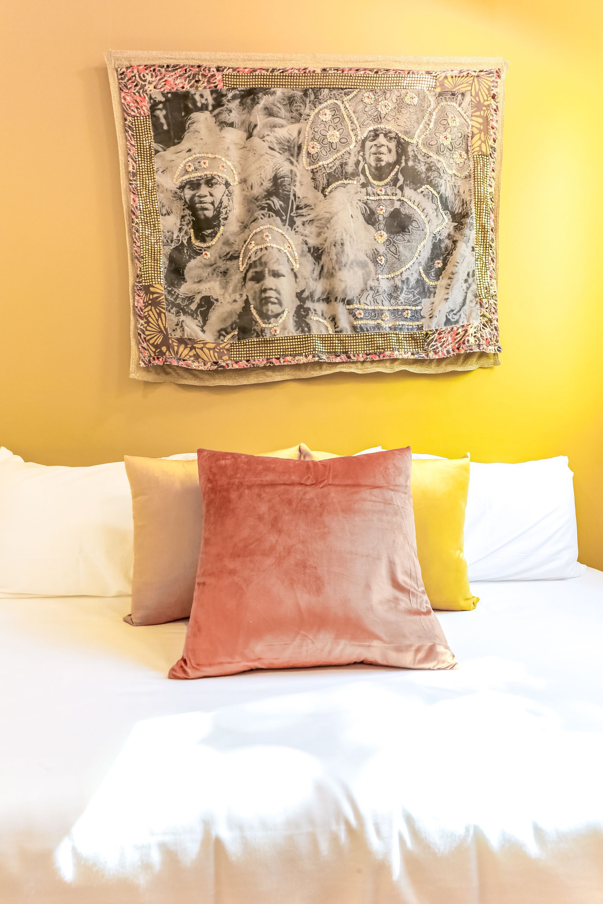 There is a painting on the wall above the bed.