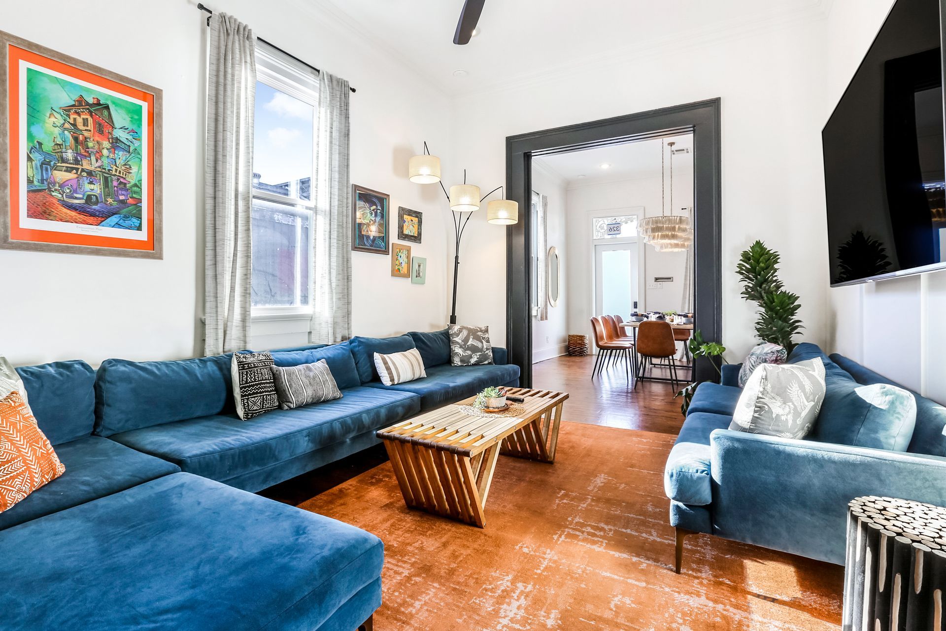 A living room with blue couches , a coffee table , and a television.