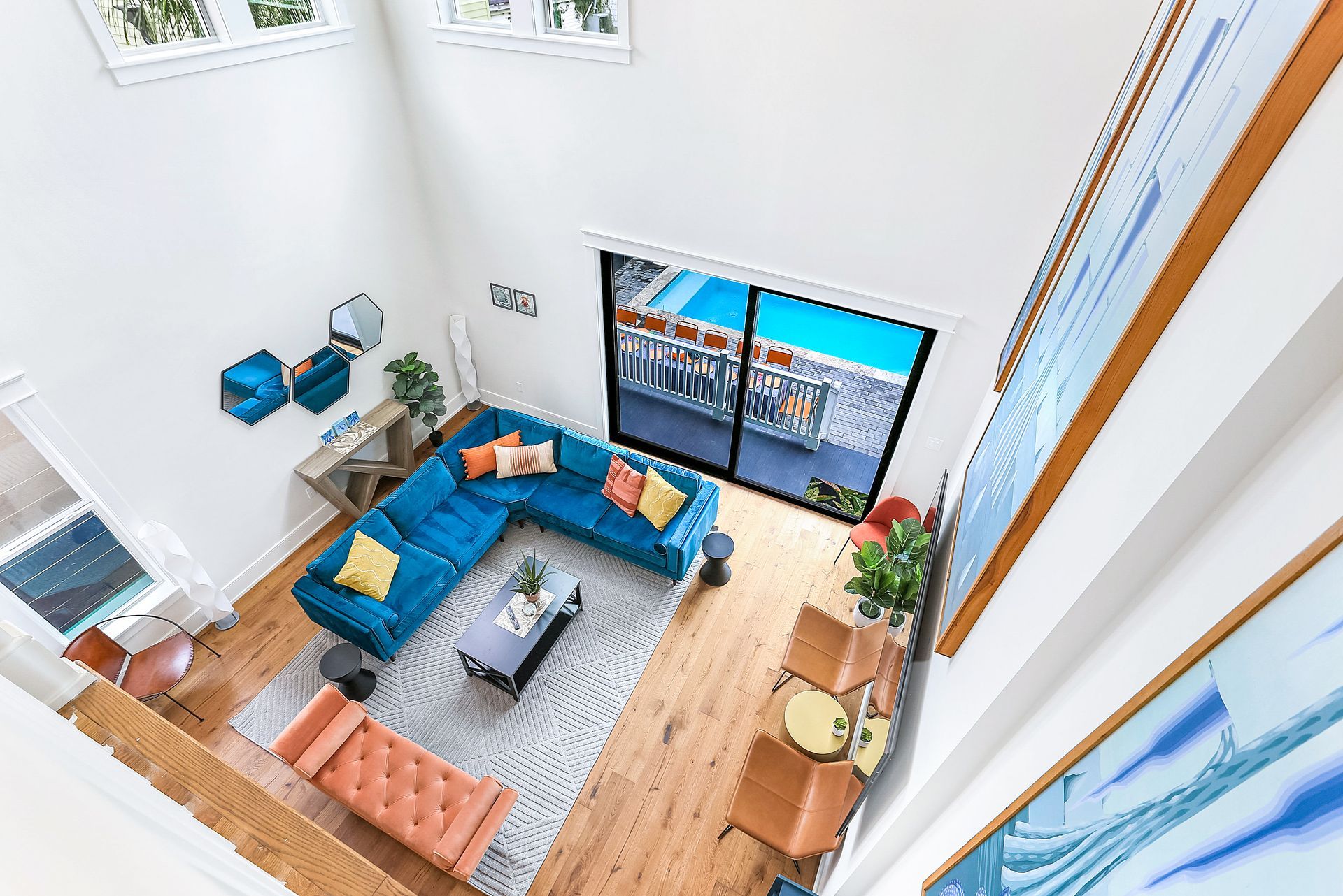 An aerial view of a living room with a blue sectional couch.