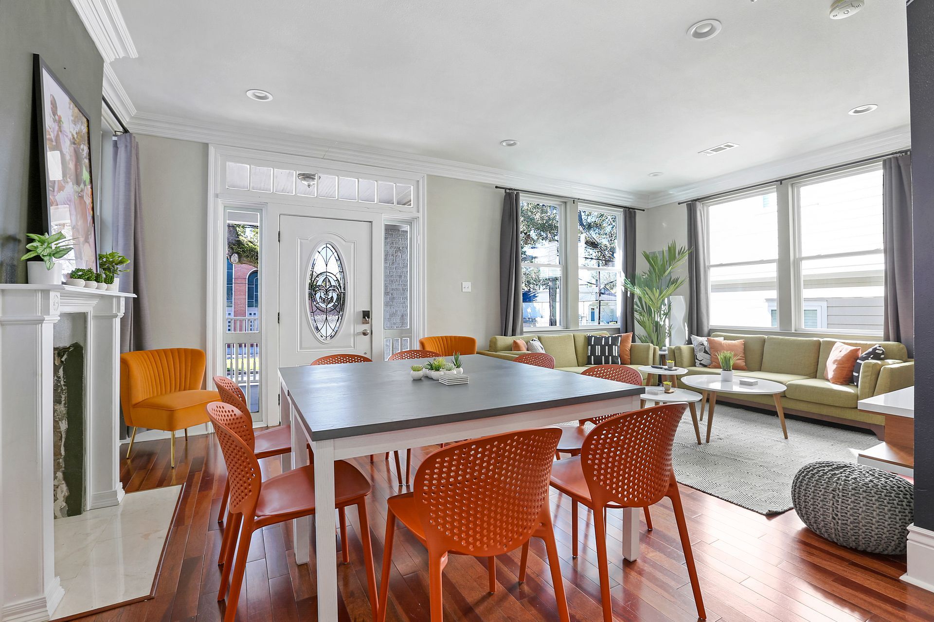 A living room with a table and chairs and a fireplace.