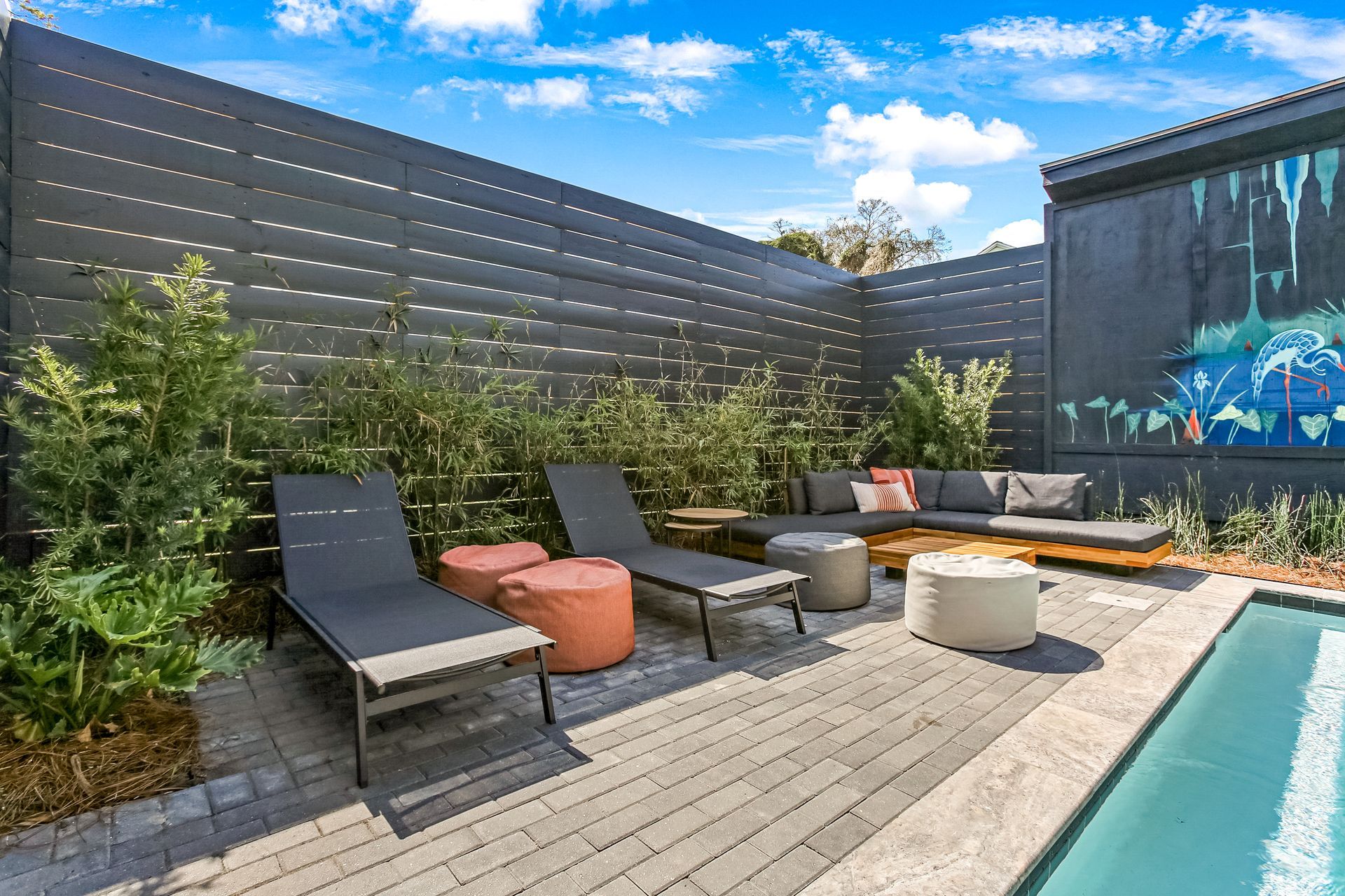 There is a swimming pool in the backyard with a fence surrounding it.