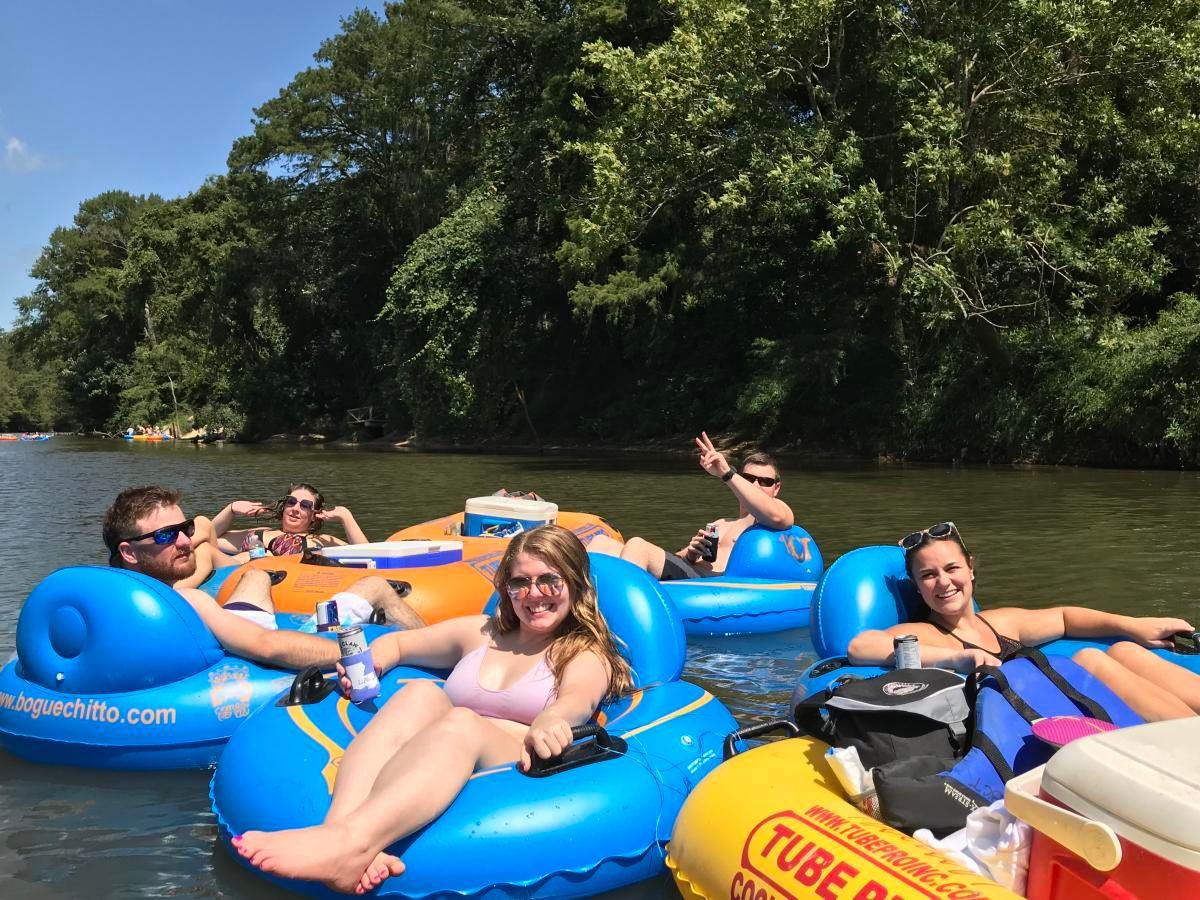 A group of people are floating down a river on rafts.