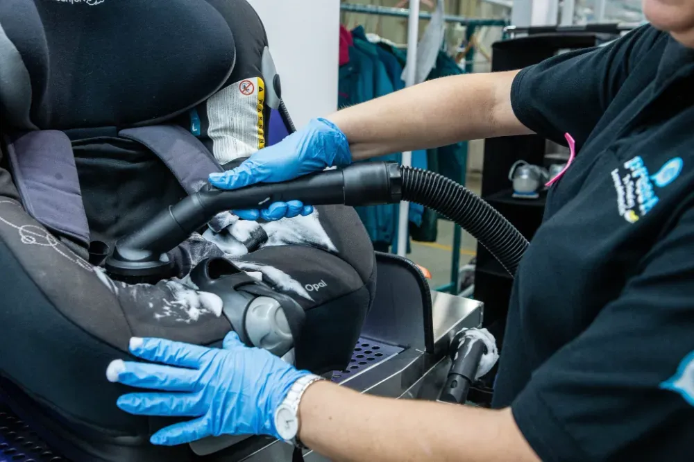 Primer plano de camisas con cuello en varios colores y rayas colgadas en perchas negras.