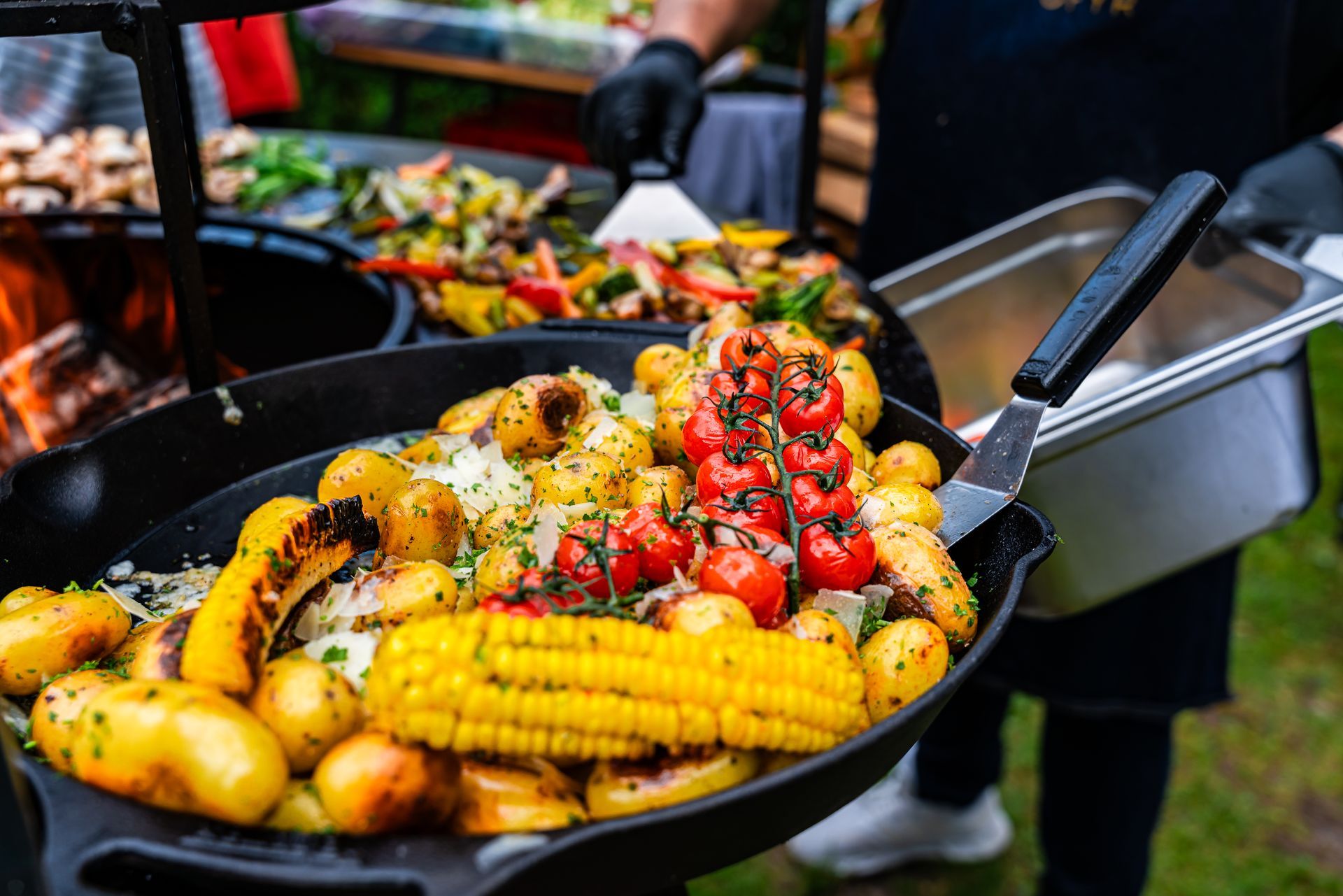 A couple is lying in bed, smiling and looking at each other. The man is holding a newspaper, the woman a cup.