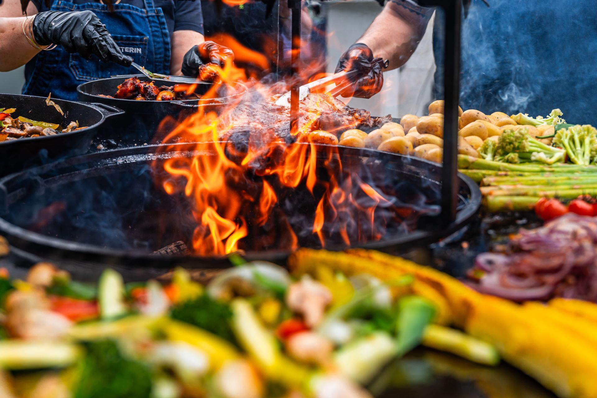 A couple is lying in bed, smiling and looking at each other. The man is holding a newspaper, the woman a cup.