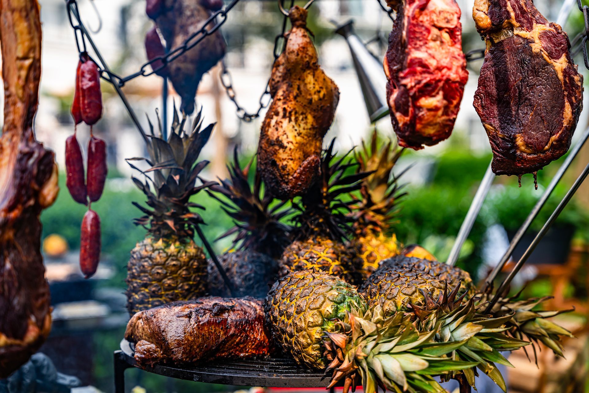 A couple is lying in bed, smiling and looking at each other. The man is holding a newspaper, the woman a cup.
