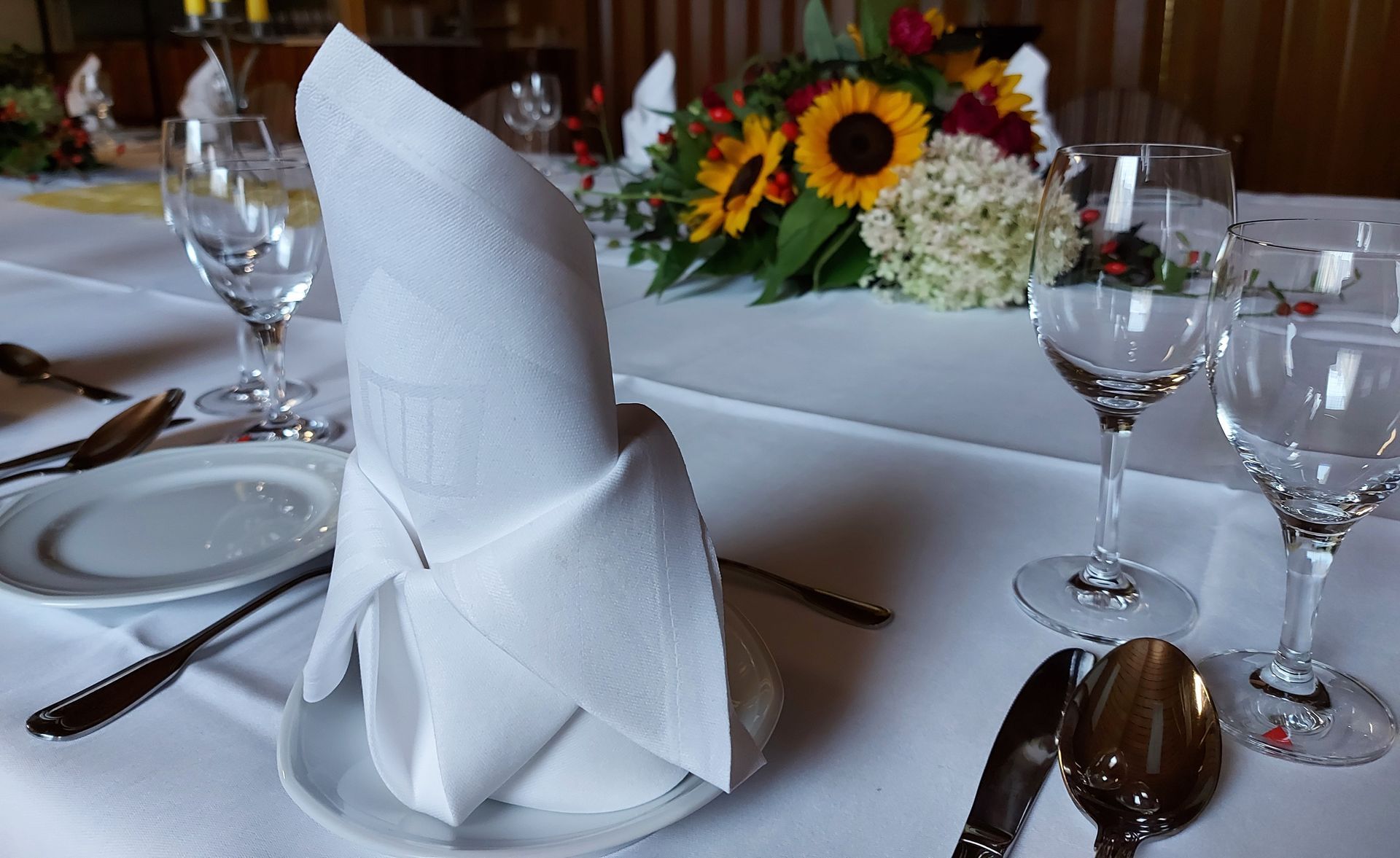 Ein Holztisch und Stühle in einem von Blumen umgebenen Garten.