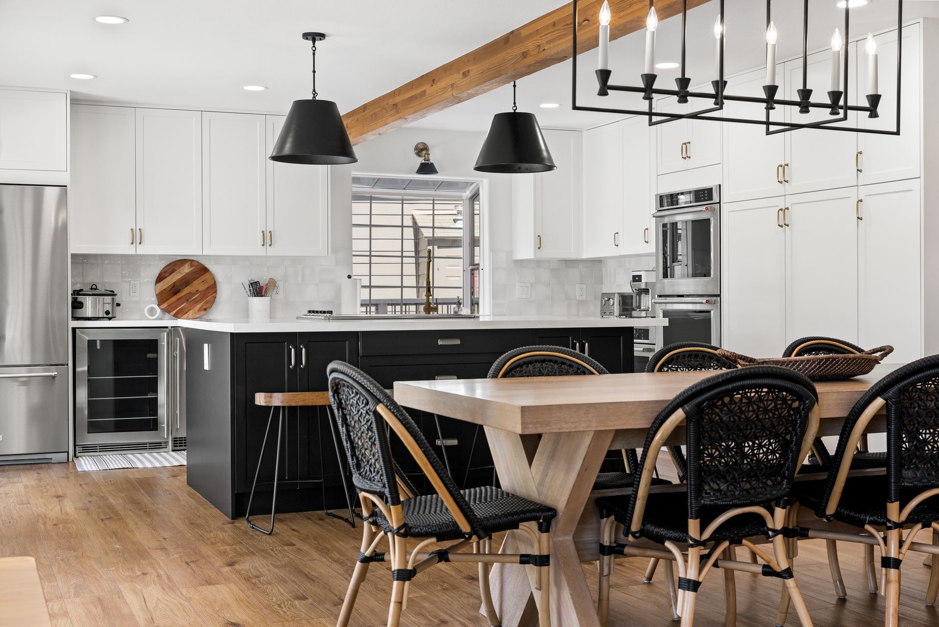 A kitchen with black and white colors.