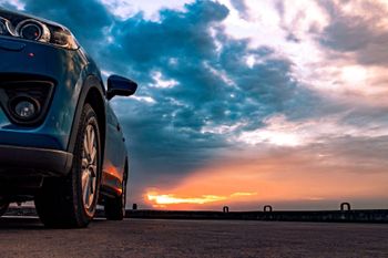Außenseite eines blauen Autos bei Sonnenaufgang