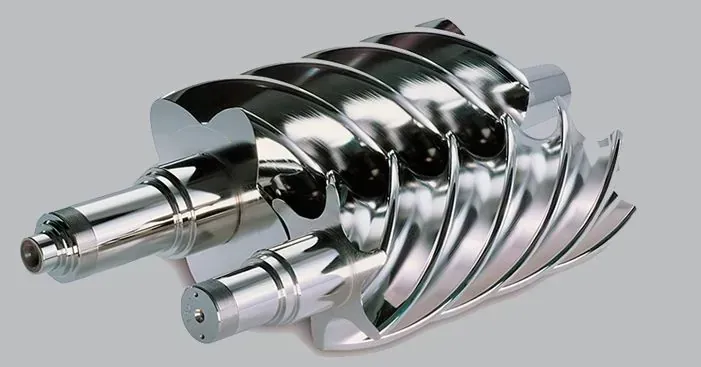 Un técnico con ropa de trabajo azul utiliza una tableta cerca de un equipo industrial con un símbolo de hidrógeno (H2).