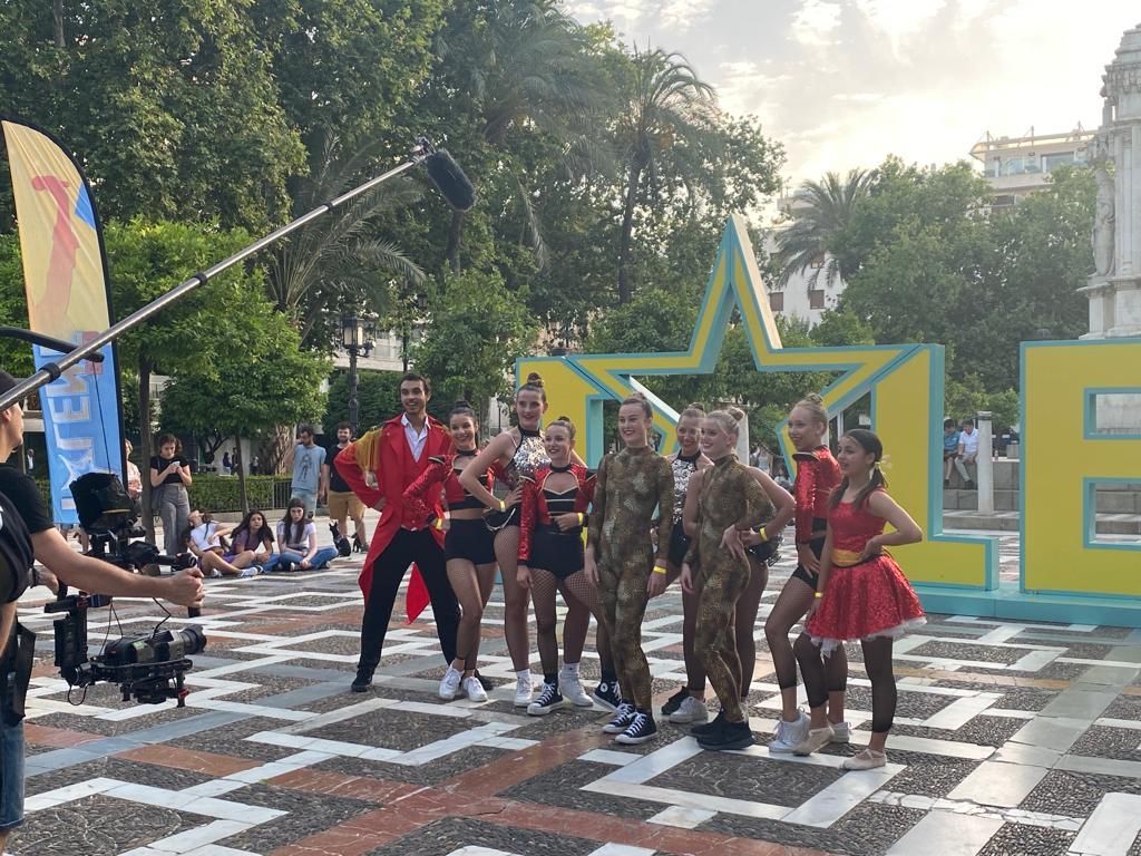 A group of people are posing for a picture in front of a large yellow star.