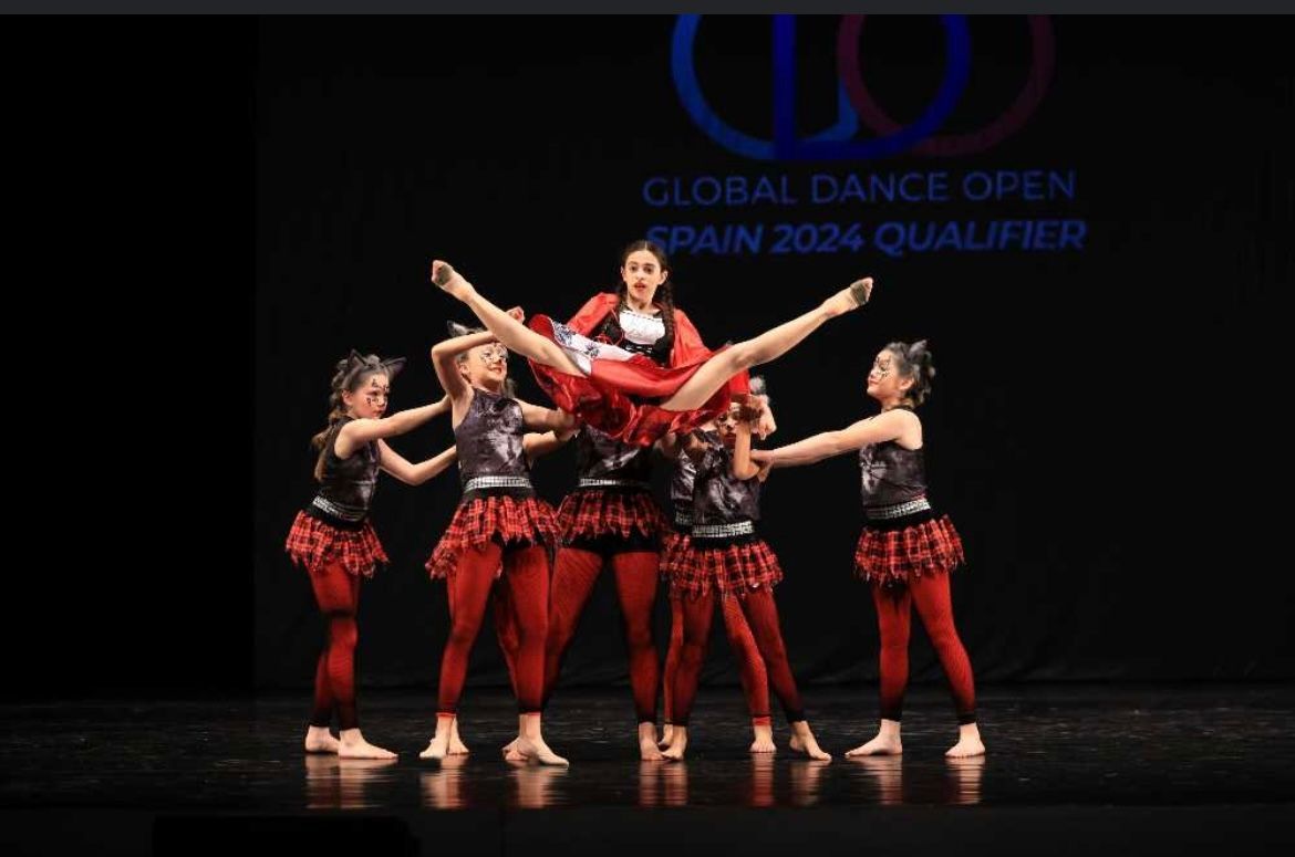 A group of young girls are performing on a stage at the global dance open